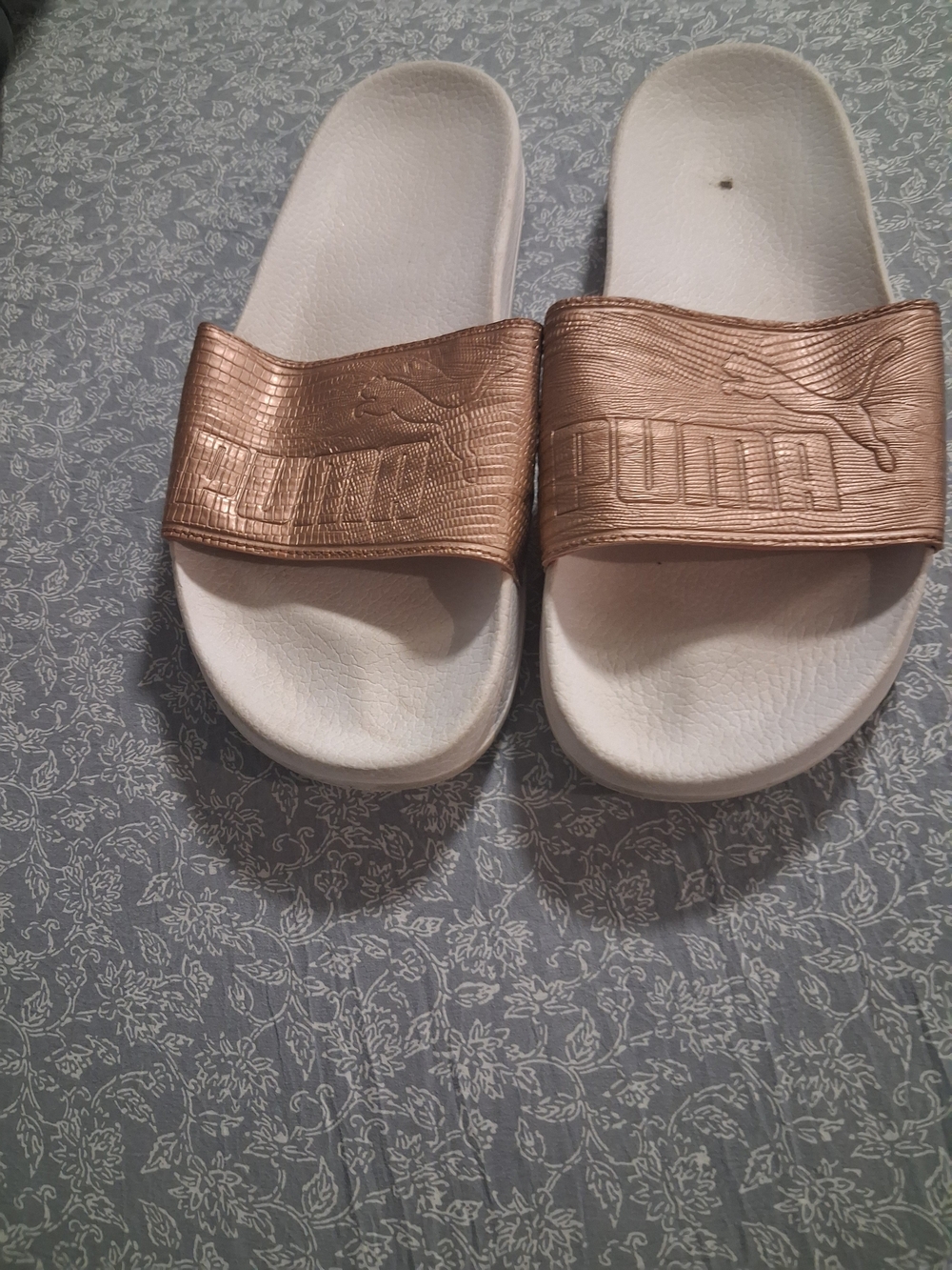 Puma Rose Gold Slide Sandals on White Base